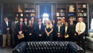 A group of associates in a courtroom with a leather couch in foreground